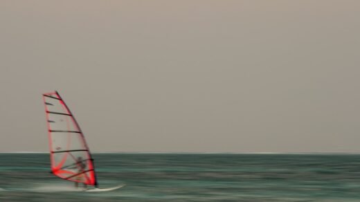 man riding parasail boat in sea