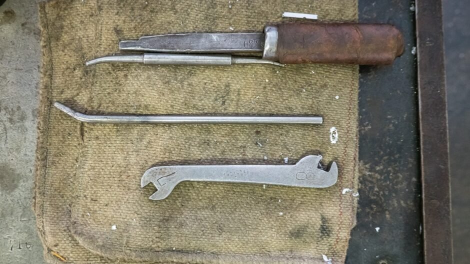 a pair of scissors and a knife on a piece of cloth