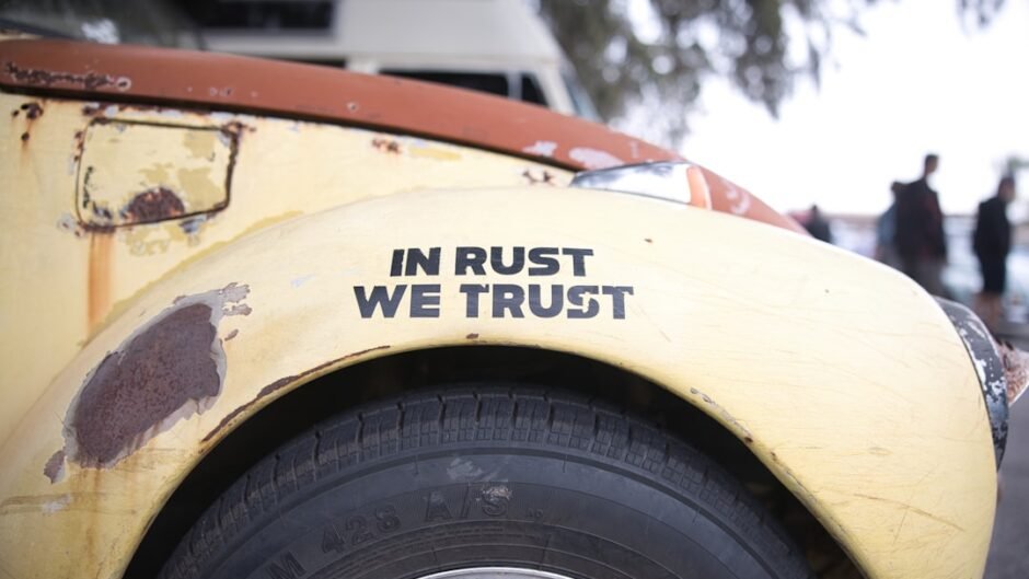 a close up of the side of a bus with rust on it