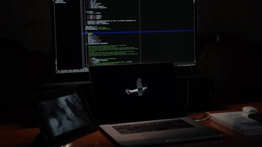a laptop computer sitting on top of a wooden desk