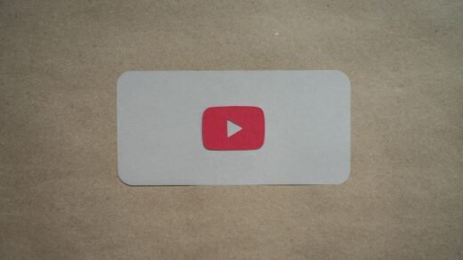 a red and white play button on a piece of paper