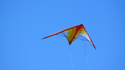 A kite flying high in the blue sky