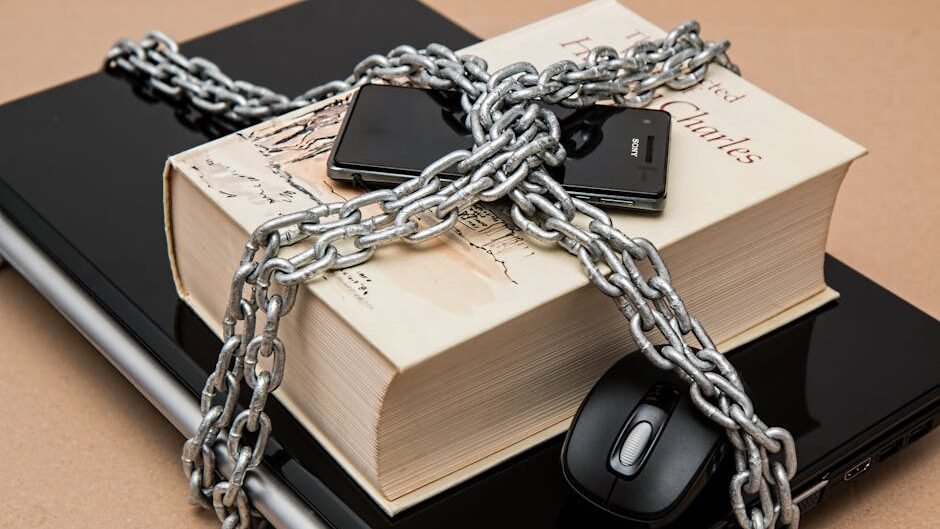 Chain-locked book, phone, and laptop symbolizing digital and intellectual security.