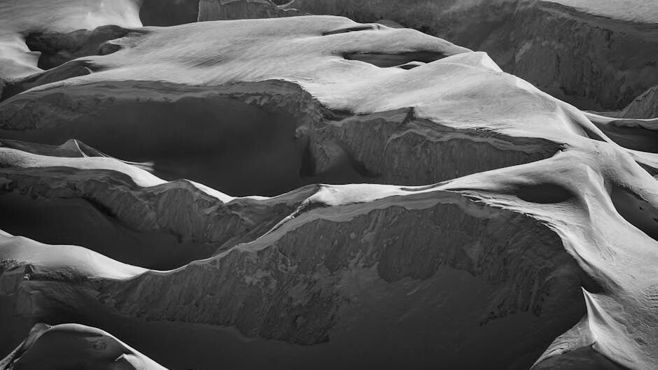 Captivating black and white photo of Saas Fee's snowy mountain formations.