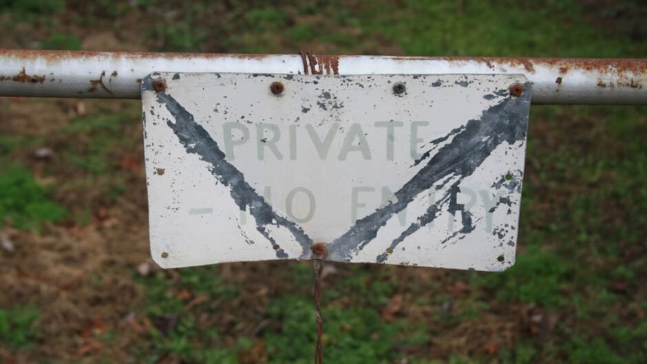 A sign that is attached to a fence