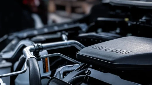 Detailed view of a car engine compartment with visible Nissan branding.