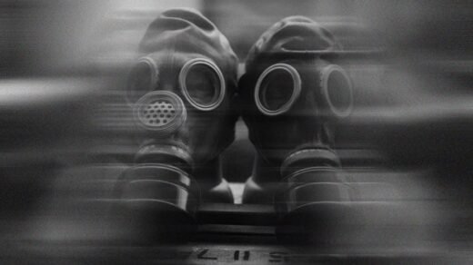 Two gas masks captured in a surreal, blurred black and white image.