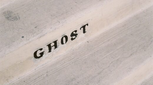 A close up of the word ghost written on a piece of wood