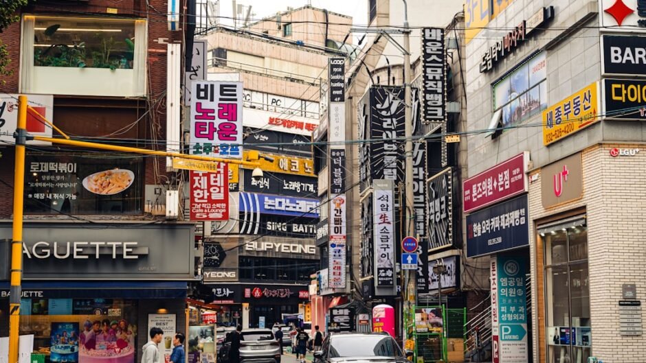 Busy street with many signs and cars in city.