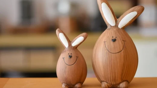 Smiling wooden bunny figures in a warm indoor setting. Perfect for Easter decor.