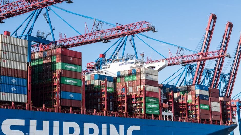 Shipping containers and cranes at Hamburg port showcasing global trade.