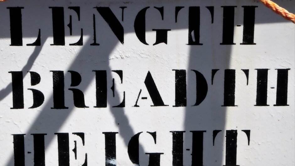 a close up of a sign with a rope attached to it