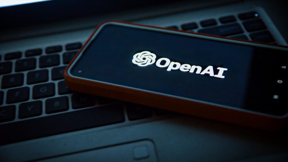 a cell phone sitting on top of a laptop computer