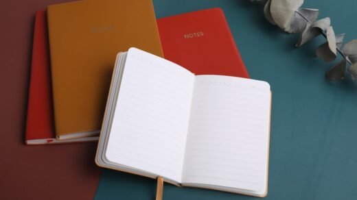 three notebooks sitting next to each other on a table