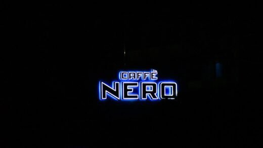 a neon sign is lit up in the dark