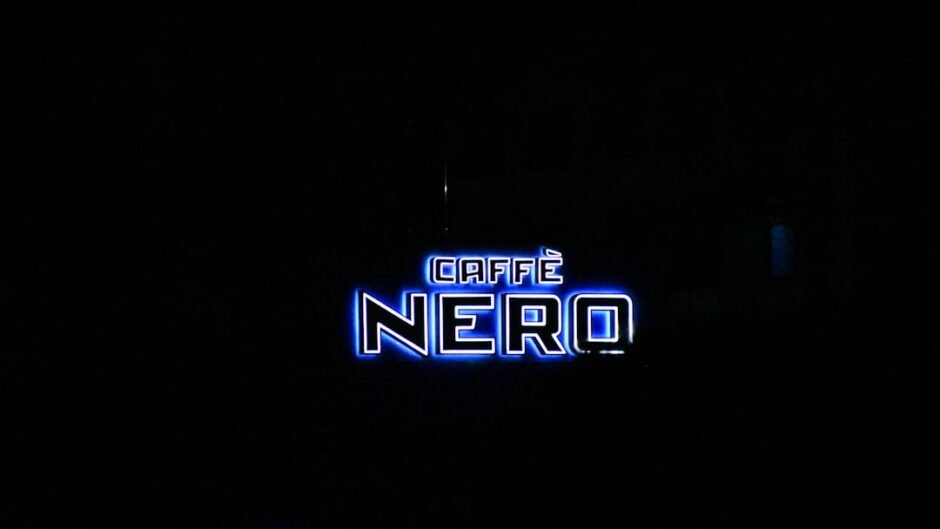 a neon sign is lit up in the dark