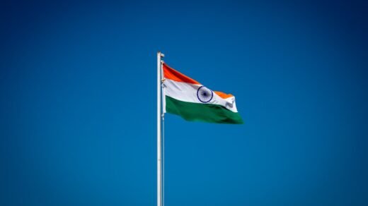 the indian flag is flying high in the blue sky