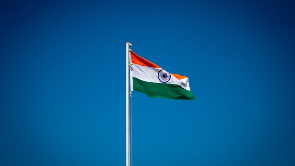 the indian flag is flying high in the blue sky
